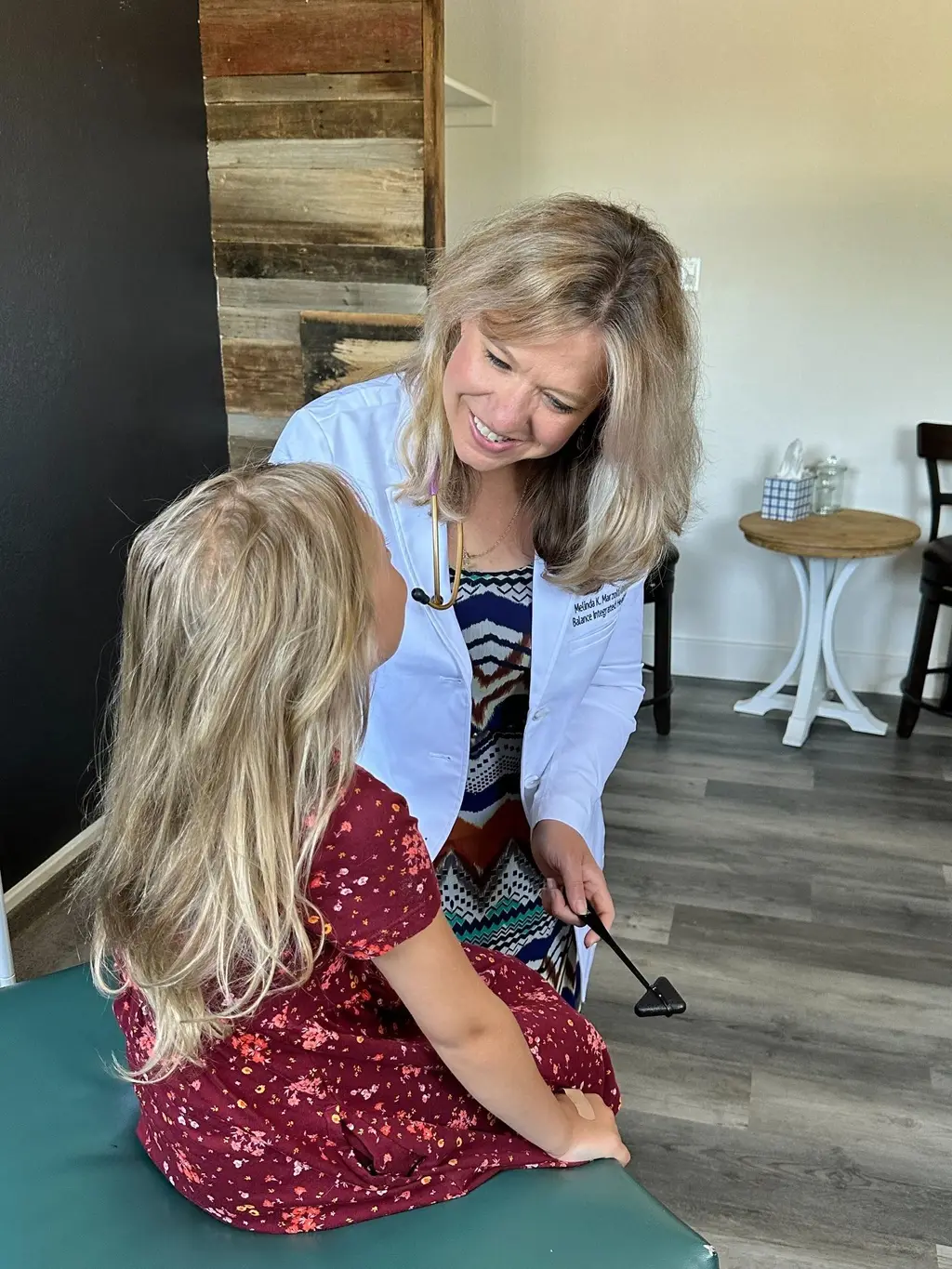 Dr. Melinda Marzolf examining a child patient — this is what DPC looks like